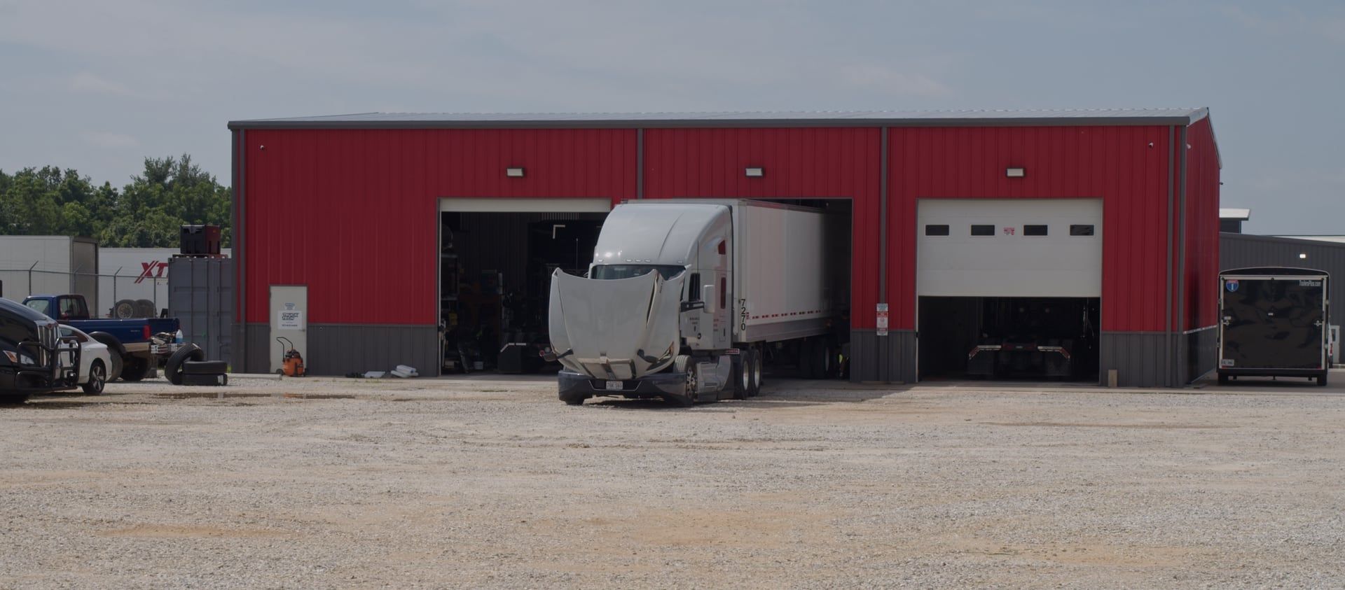 A Safe Way Carrier truck with its hood up at the in-house shop