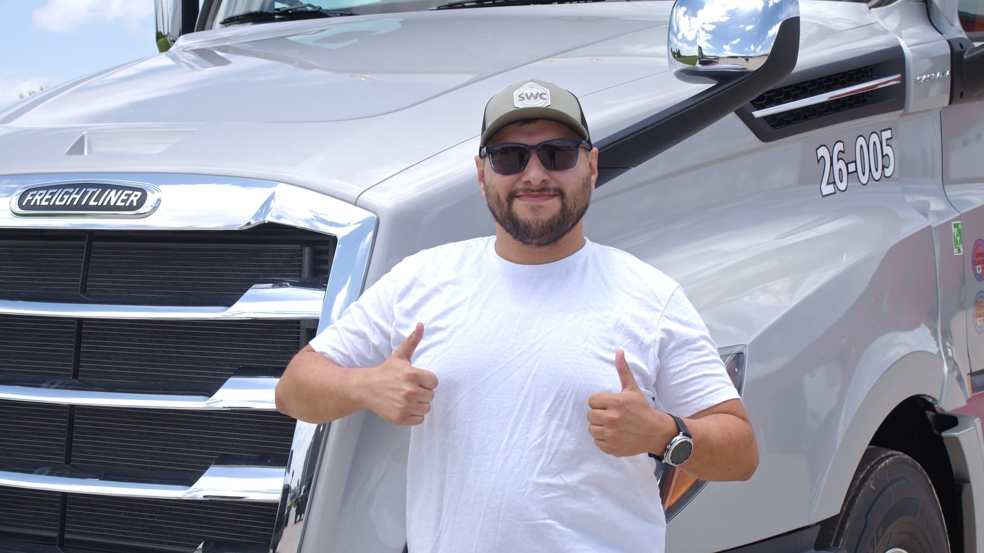 A Safe Way Carrier driver giving a thumbs up by the truck