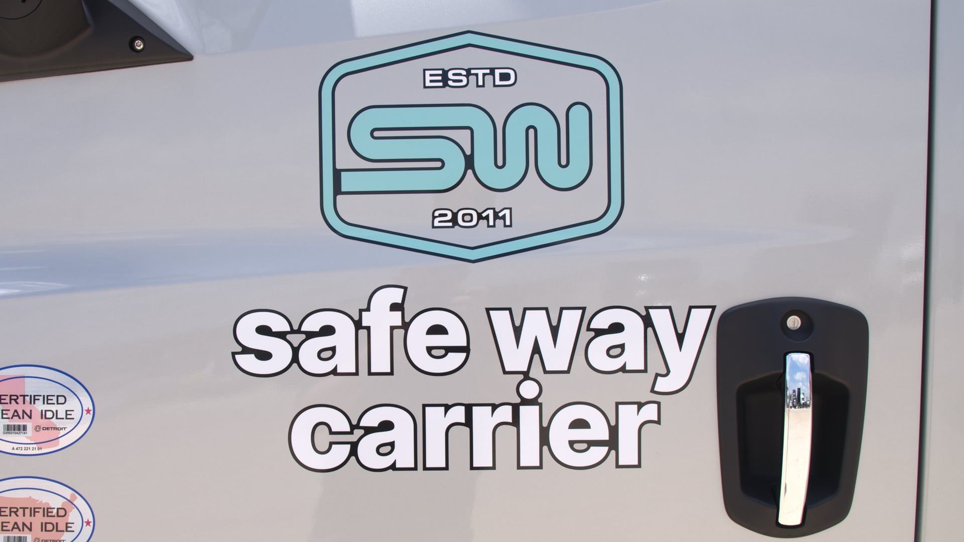 The Safe Way Carrier logo on a truck door